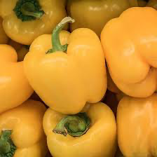 A pile of bright yellow bell peppers.