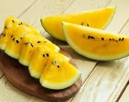 Golden Honey watermelon wedges with yellow flesh and dark seeds — from BlackOwnedSeeds.com.